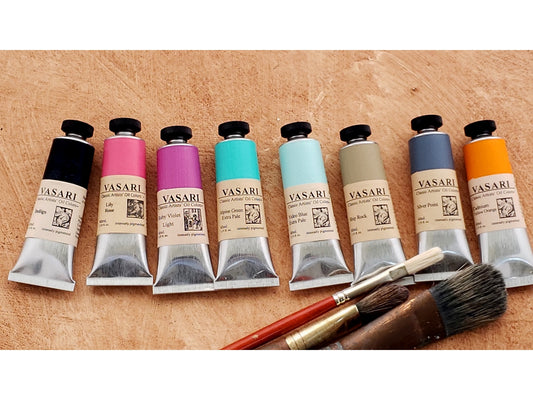 Seth Tummins Colors for a Landscape set imaged with brushes at bottom, from left to right, are 40ml tubes of Vasari Classic Artists' Oil Colors: Indigo, Lily Rose, Ruby Violet Light, Alpine Green Extra Pale, Video Blue Extra Pale, Ship Rock, Silver Point, and Cadmium Yellow Orange.
