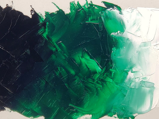 Imaged at center is the Phthalo Green, yellow shade with Ivory Black mixing into it from the left. Titanium White, at far right, tints the Phthalo Green, yellow shade and gives it opacity as it lightens the value at right.