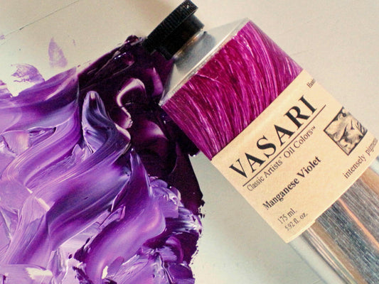 Large tube of Manganese Violet imaged above the paint right from the tube with white mixing in from the lower left.