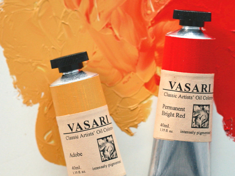 Tubes of our Adobe, at left, and our Permanent Bright Red, at right, imaged above the paint with the two colors mixed together at center. 